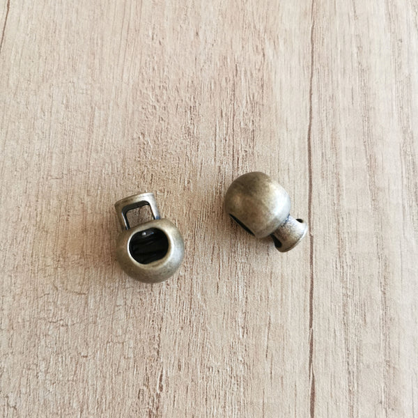 Lot de 2 stops cordons boule métal bronze
