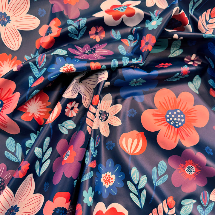 Tissu imperméable ciré bleu encre fleur rouge et bleu