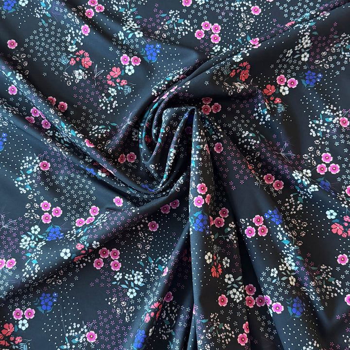 Tissu stretch noir imprimé petit magnolia