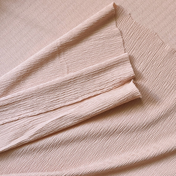 Tissu crépon stretch rose nude