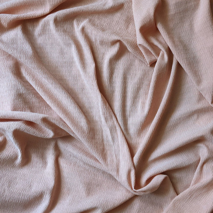 Tissu crépon stretch rose nude
